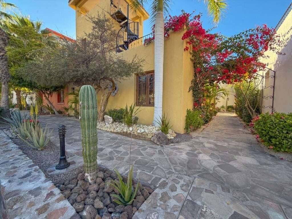 Loreto Founders FN 408 is a stunning 3 bedroom, 3-bathroom Encantada home that features handicapped accessibility and convenient interior access to a ground-level en-suite, all situated in the desirable Founders Neighborhood. This bright and airy 3-bedroom, 3-bathroom corner residence is bathed in natural light. Upon entering the ground level, you'll find a cozy interior courtyard that has been thoughtfully transformed into a welcoming sitting area. The open-concept kitchen and living space boast windows that overlook a serene community courtyard. The spacious primary en-suite, equipped for accessibility, provides an ideal living arrangement on this level, complete with a walk-in closet and double vanities. Additionally, there is a charming guest bedroom and a full bathroom.On the second floor, you'll discover a generous terrace featuring a wooden pergola for shade, along with a lounge and BBQ area that offers picturesque – Calle Agua Dulce, Loreto, BS