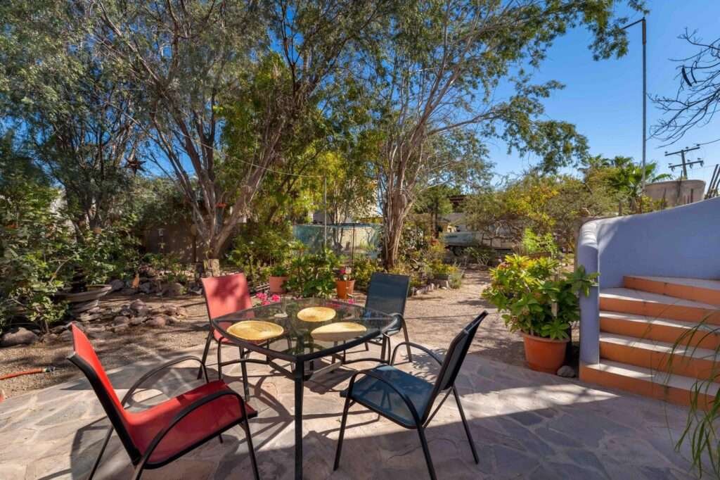 Loreto Centro Casa Isla Danzante — Charming 3BR Home on a Large Lot with established garden and covered boat parking in Historic LoretoWelcome to Casa Isla Danzante, a delightful two-story home blending traditional Loreto character with modern comforts. Situated on a generous 10,570 sq ft double lot on a quiet street in the heart of historic Loreto, this 1,500 sq ft residence offers space, privacy, and excellent potential — room to park a boat under cover, grow a garden, or add a casita or workshop.Two bedrooms on the second level, each with its own entranceOpen flow between kitchen, dining and living ar Study/office nook and large pantry for extra storageFully updated kitchen and A/COutdoor Features & SystemsLarge covered parking area for boat/RV storageProtected garden area with rich soil and drip irrigationLush, mature landscaping with shade trees a haven for birds and lizardsUpstairs terraza with mountain – Isla Danzante, Loreto, BS