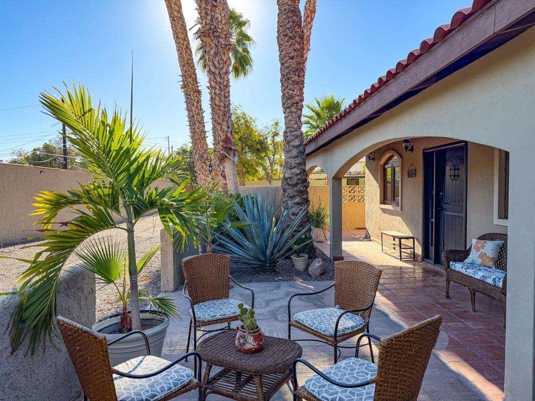 Loreto Centro Coastal Hideaway -- 2bed/2bath + Studio, Covered Parking & Lot to expand in LoretoTurnkey Gated Retreat -- 2BR/2BA Home + Detached Studio with Developable Walled Lot.Located steps to the beach and marina!Tucked down a driveway and set back from the street, this renovated single-level home is just one block from the beach and marina and four blocks from the historic plaza. Bright and airy, the 2-bed, 2-bath residence features vaulted ceilings, vinyl windows and beautifully preserved Saltillo tile floors throughout. The updated kitchen and bathrooms offer modern finishes, granite countertops and stainless-steel appliances. Enjoy the covered front porch or a tranquil, shaded backyard surrounded by mango, fruit and palm trees.The property includes a detached studio with a kitchene perfect for guests or rental income--and an enclosed secure storage building and covered carport located across from the house. The entire property is fully walled and gated for privacy and security. Additionally, a 4,593 sq ft walled rear lot is ready to develop with potential sea and mountain for sale