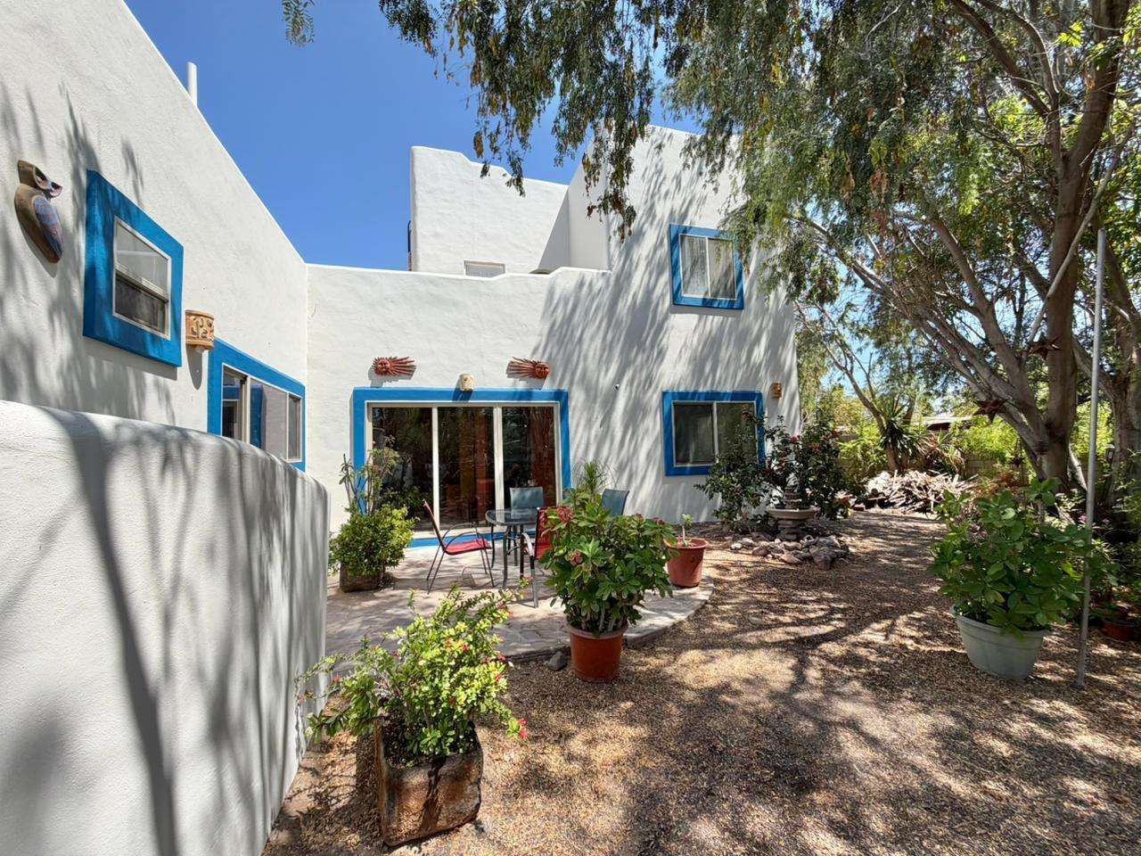 Loreto Centro Casa Isla Danzante — Charming 3BR Home on a Large Lot with established garden and covered boat parking in Historic LoretoWelcome to Casa Isla Danzante, a delightful two-story home blending traditional Loreto character with modern comforts. Situated on a generous 10,570 sq ft double lot on a quiet street in the heart of historic Loreto, this 1,500 sq ft residence offers space, privacy, and excellent potential — room to park a boat under cover, grow a garden, or add a casita or workshop.Two bedrooms on the second level, each with its own entranceOpen flow between kitchen, dining and living ar Study/office nook and large pantry for extra storageFully updated kitchen and A/COutdoor Features & SystemsLarge covered parking area for boat/RV storageProtected garden area with rich soil and drip irrigationLush, mature landscaping with shade trees a haven for birds and lizardsUpstairs terraza with mountain for sale