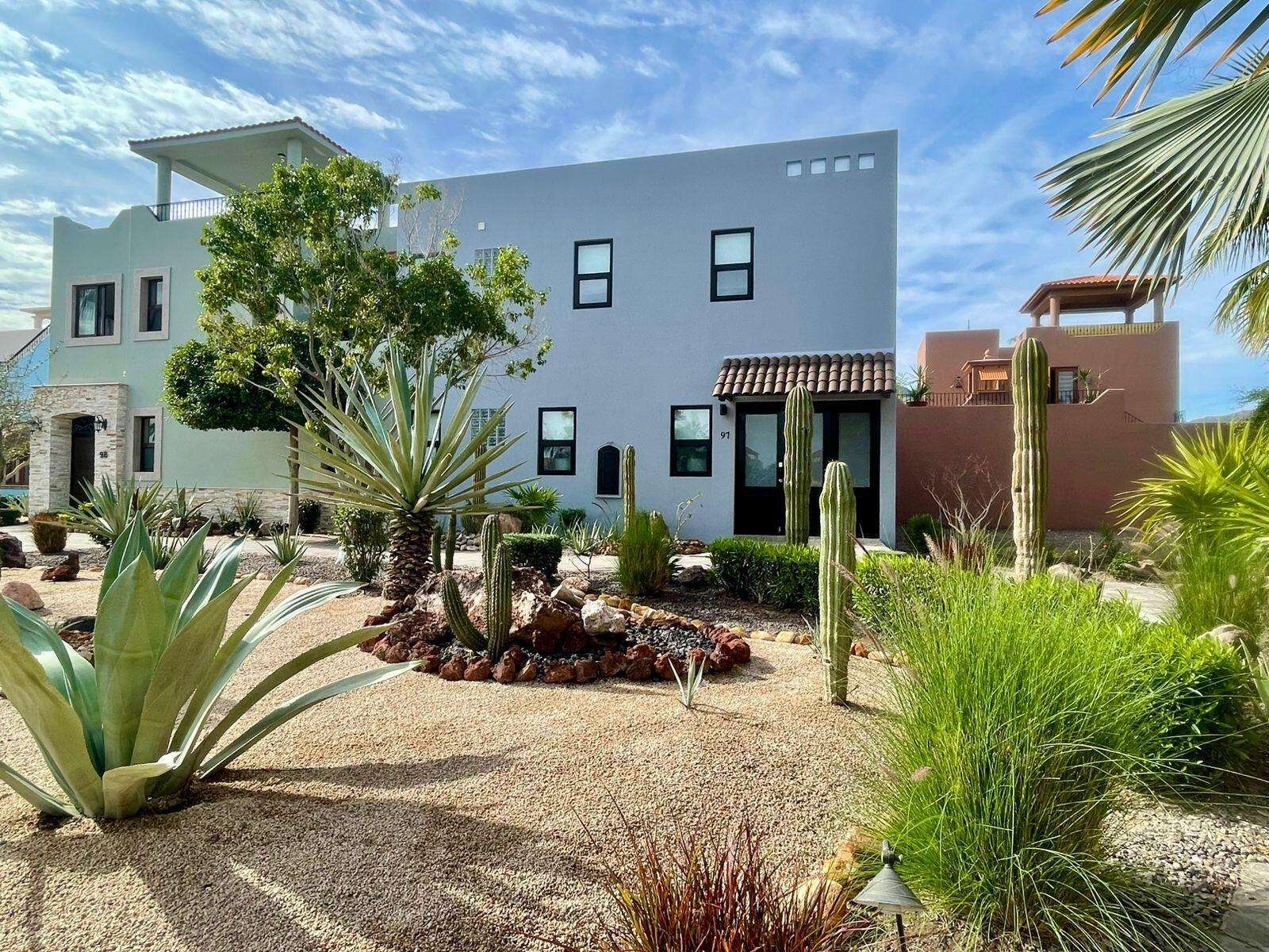 Loreto Agua Viva Discover unparalleled luxury in this custom-designed village home featuring 3 bedrooms, 3.5 bathrooms, plus a versatile flex room that easily converts into a fourth bedroom. Offering approximately 2,400+ sq ft of refined living space, the residence blends seamless indoor-outdoor flow with premium finishes, including granite countertops and porcelain tile throughout. Two spacious master suites—one on the main level and one upstairs—each feature deluxe ensuites and generous closets. The flex room off the kitchen is ideal for an office, media room, or guest suite. Outdoors, enjoy a private 6-person jacuzzi, water feature, and expansive outdoor kitchen and living area. A sunny terrace and third-level for sale